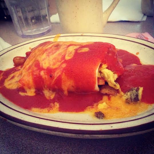 The best burrito in the world: sausage, egg, potato and cheese, smothered in red chili